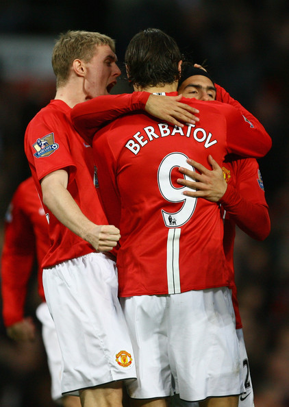 Berbatov hugs Tevez and Fletcher as Manchester United celebrate a goal